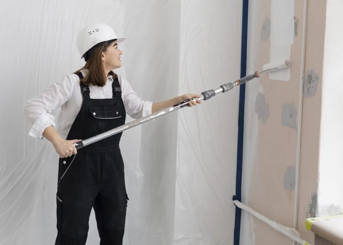 woman-painting-house-wall-full-shot-min